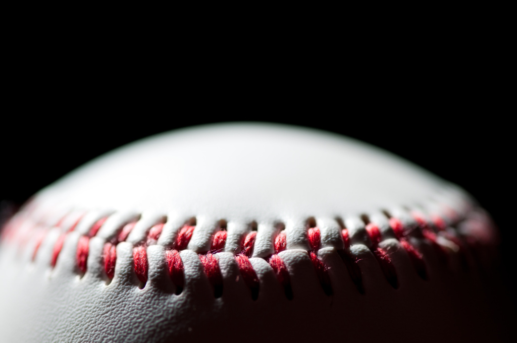 Baseball over black background, horizontal shot