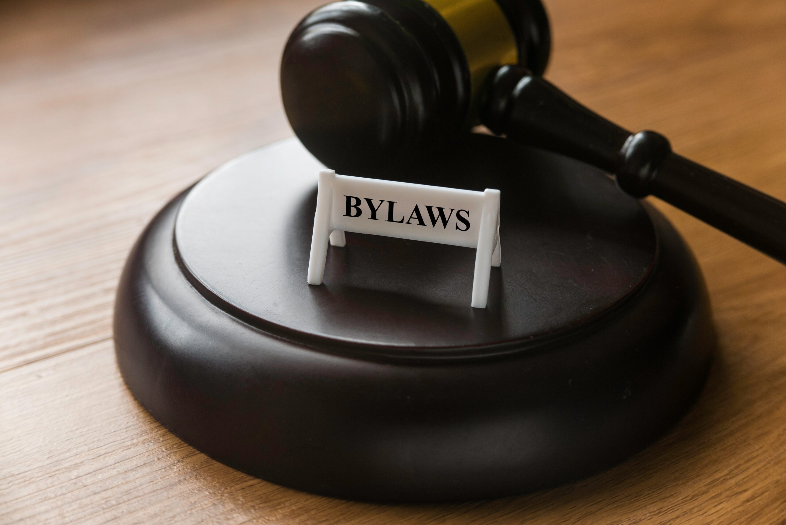 Bylaws phrase with gavel on wooden background