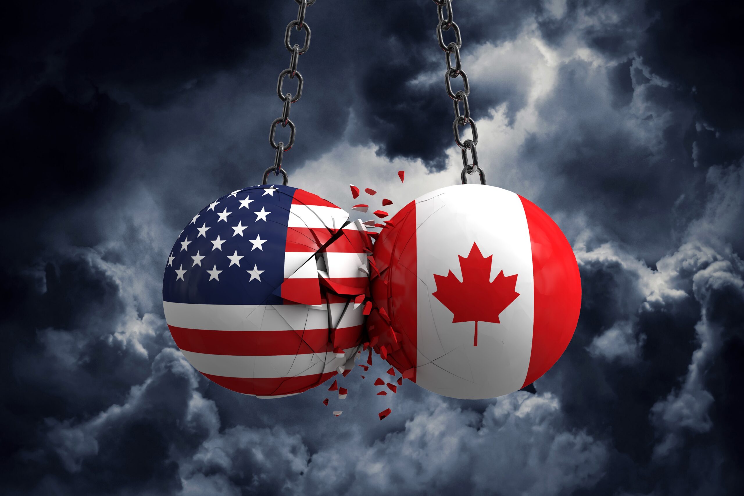 Wrecking balls with U.S. and Canada flag symbols crashing into each other and showing cracks