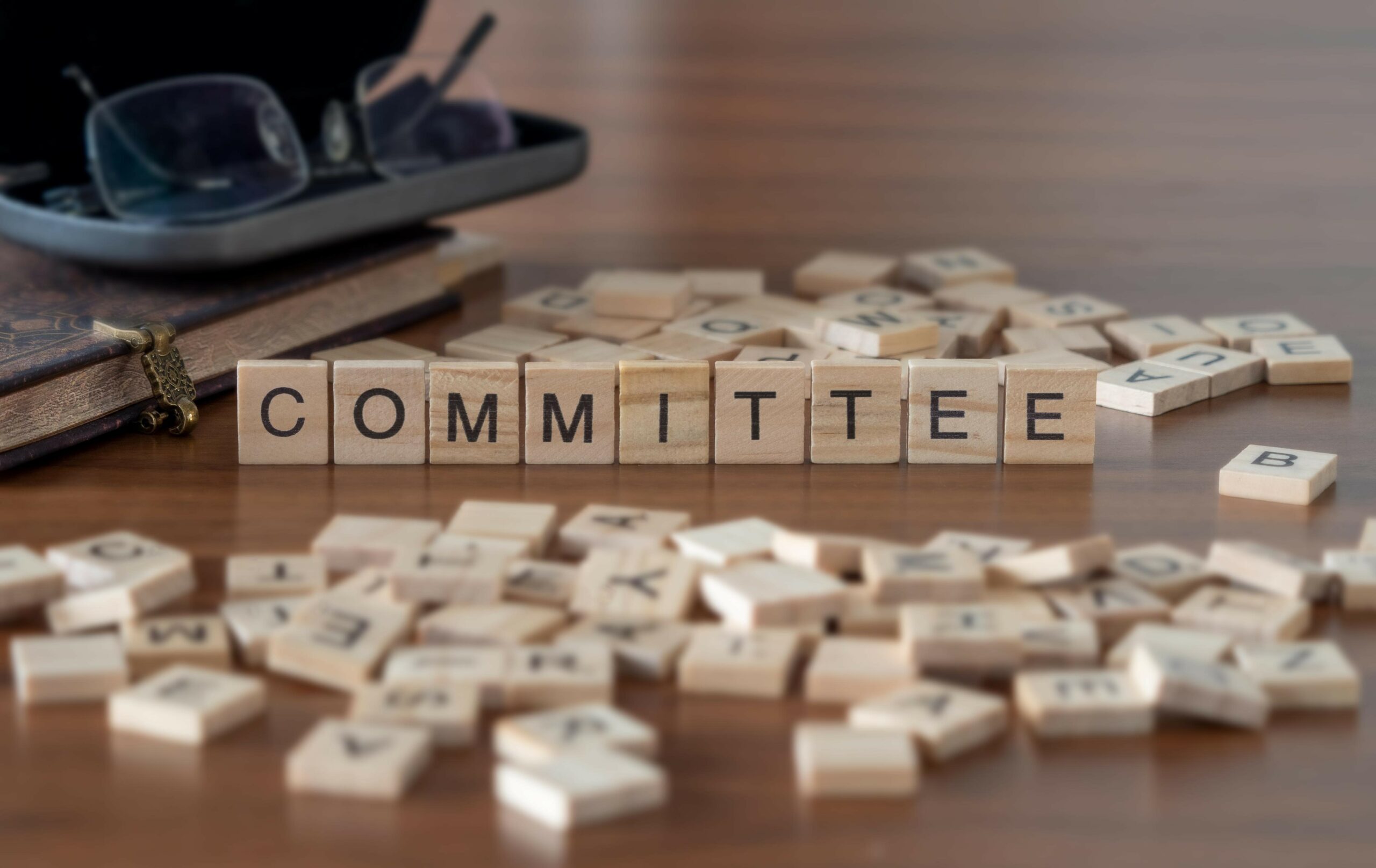 "committee" represented by wooden letter tiles