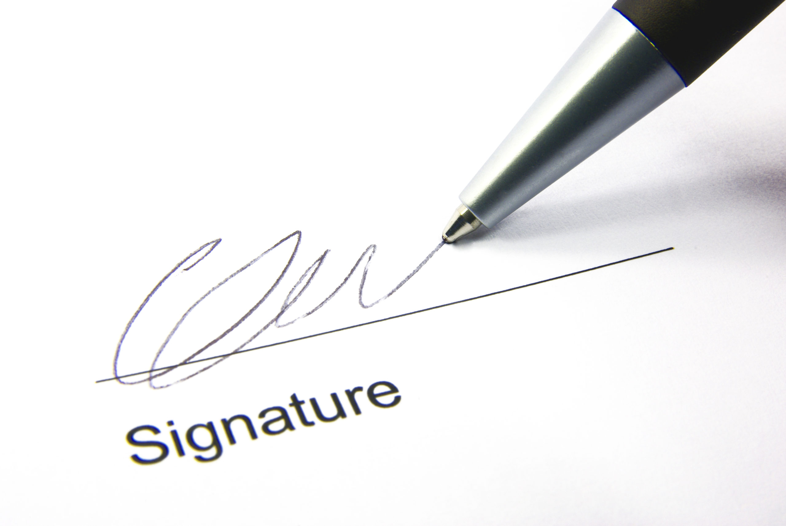 Detail view of the signature box of a contract with a pen.