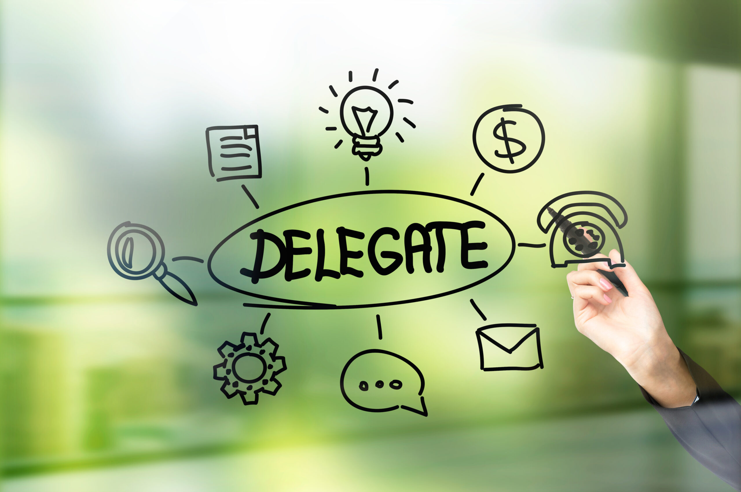 Businesswoman hand drawing delegate sketch on green background