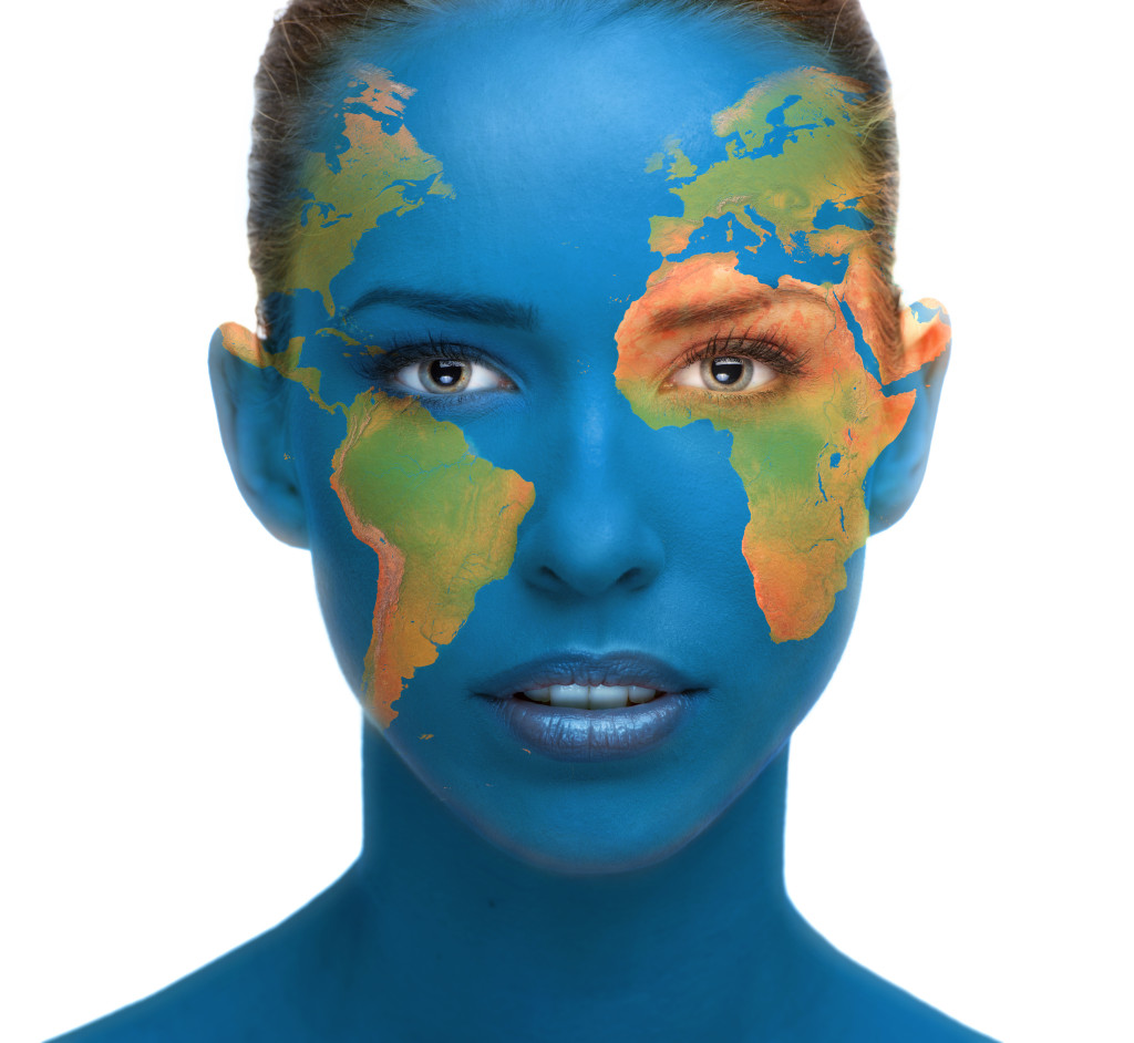 Beautiful woman face close up with planet Earth texture