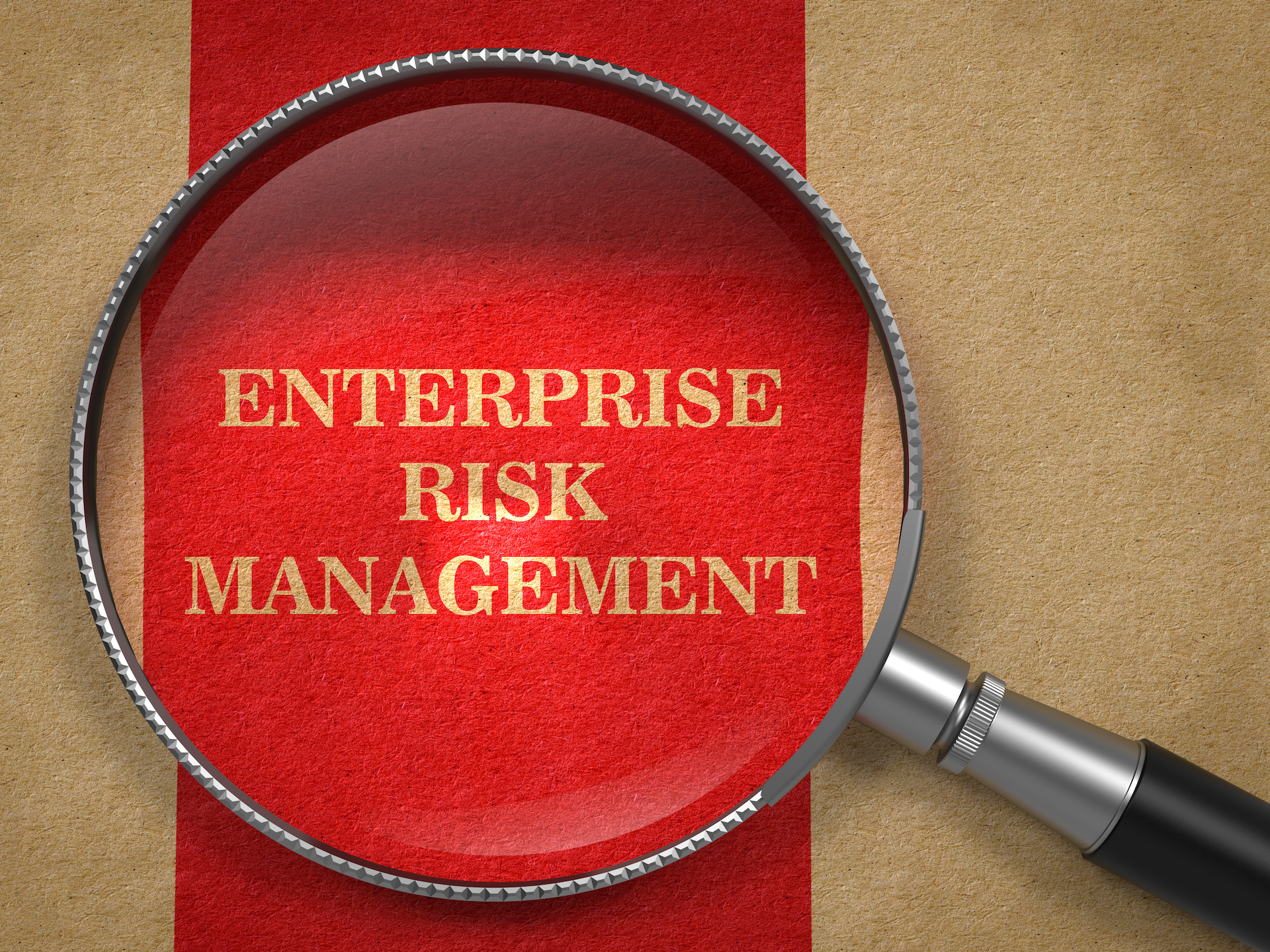 "Enterprise Risk Management" text under Magnifying Glass on Old Paper with Red Vertical Line.