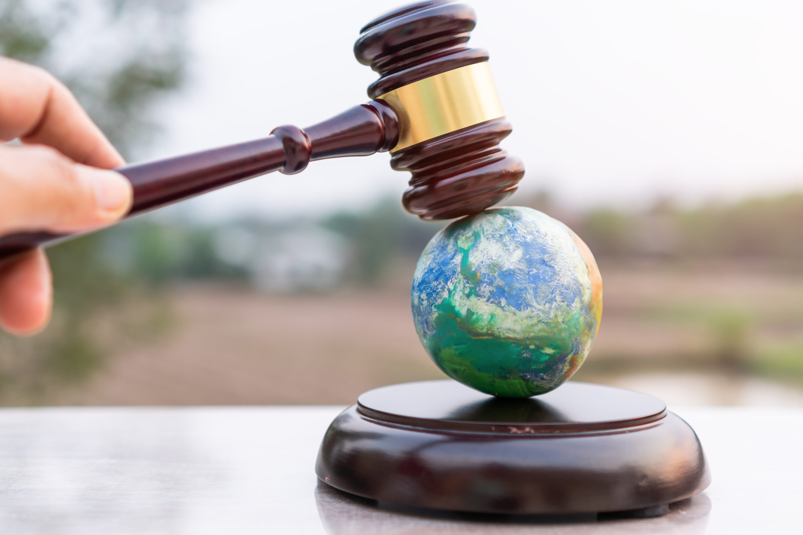 Earth destruction and destroy environmental by hand human concept. Judge gavel