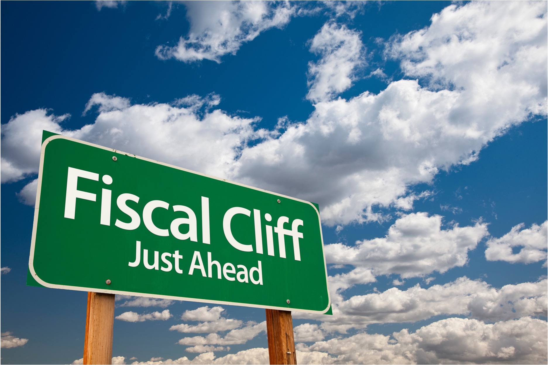 "Fiscal Cliff Just Ahead" highway sign against background of sky and clouds