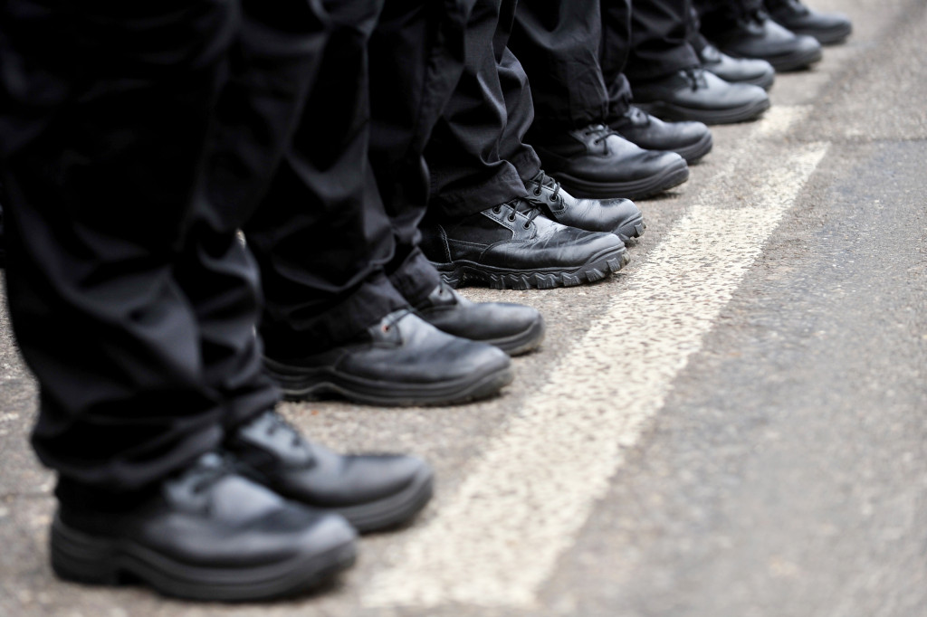 Detail with black military boots in a row during parade