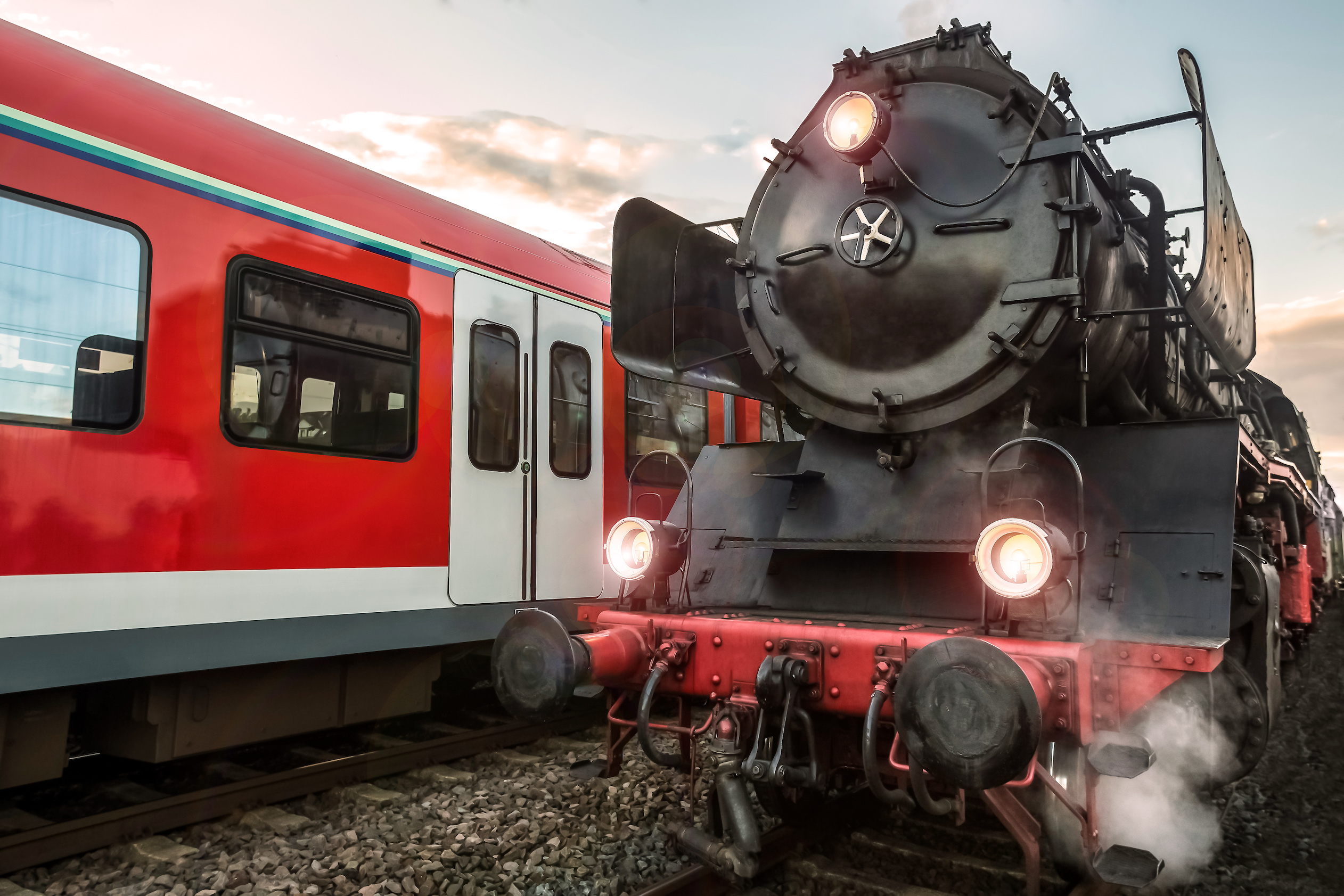 old steam train and modern electric train in a race