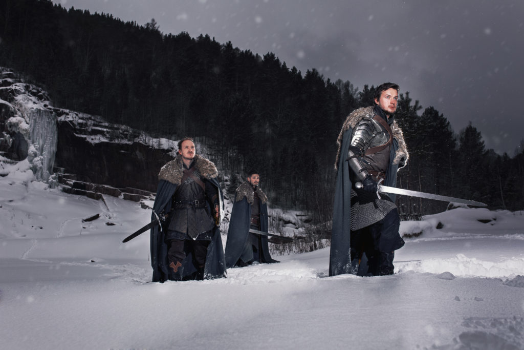 Medieval knight with sword in armor as style Game of Thrones in Winter Rock Landscapes