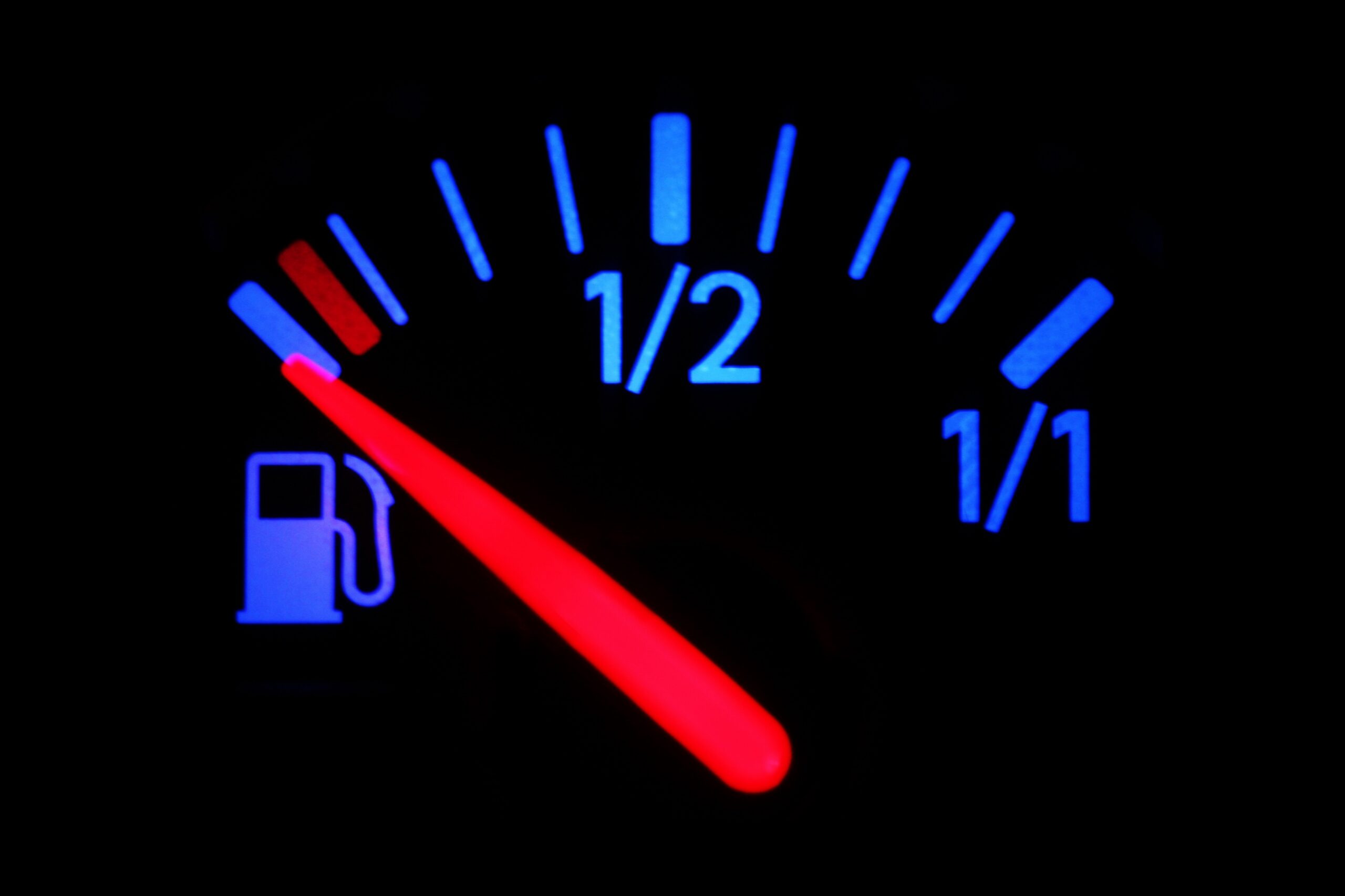 Car dashboard gage indicating empty gas tank.