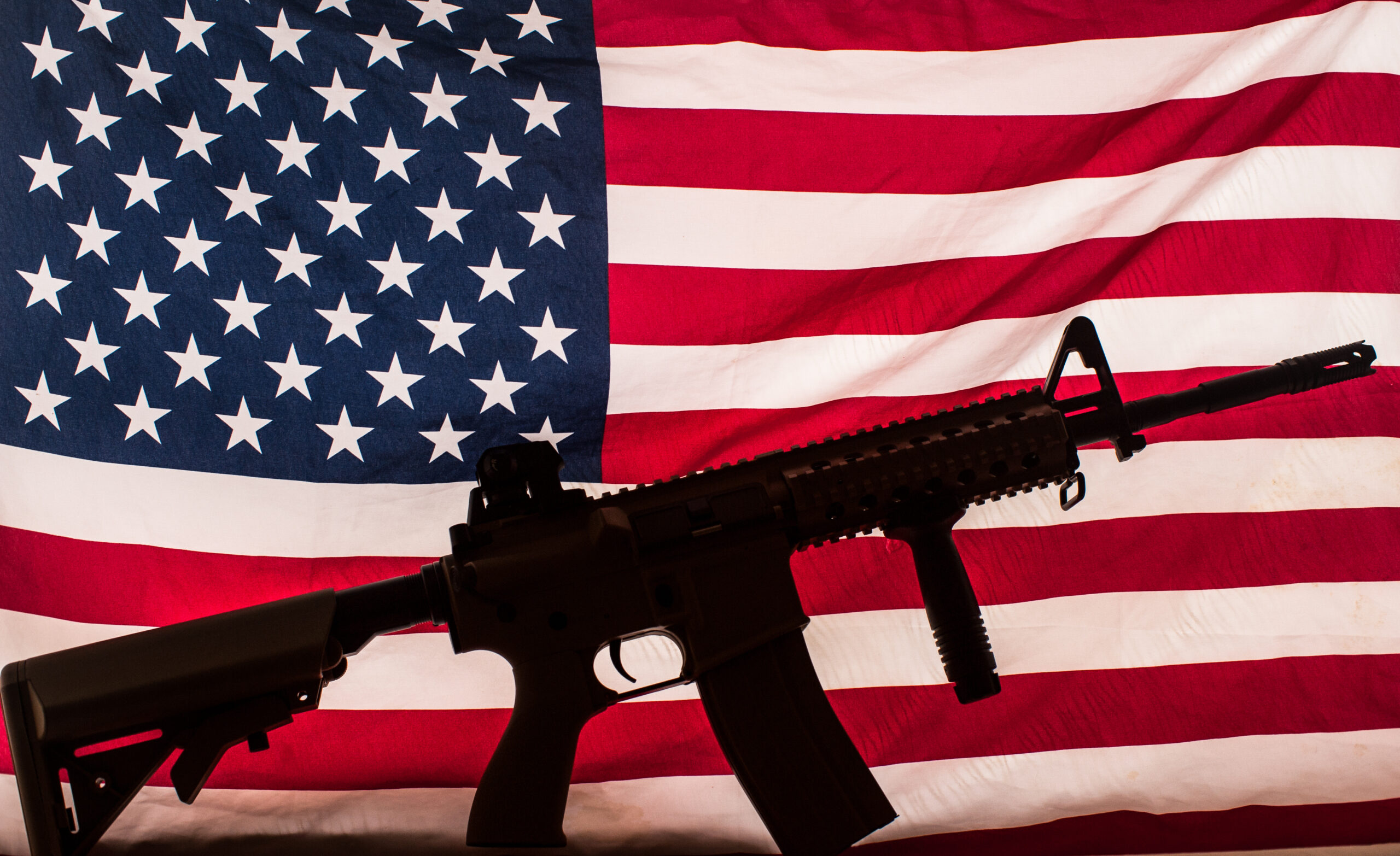 gun (AR-15) silhouette on American flag