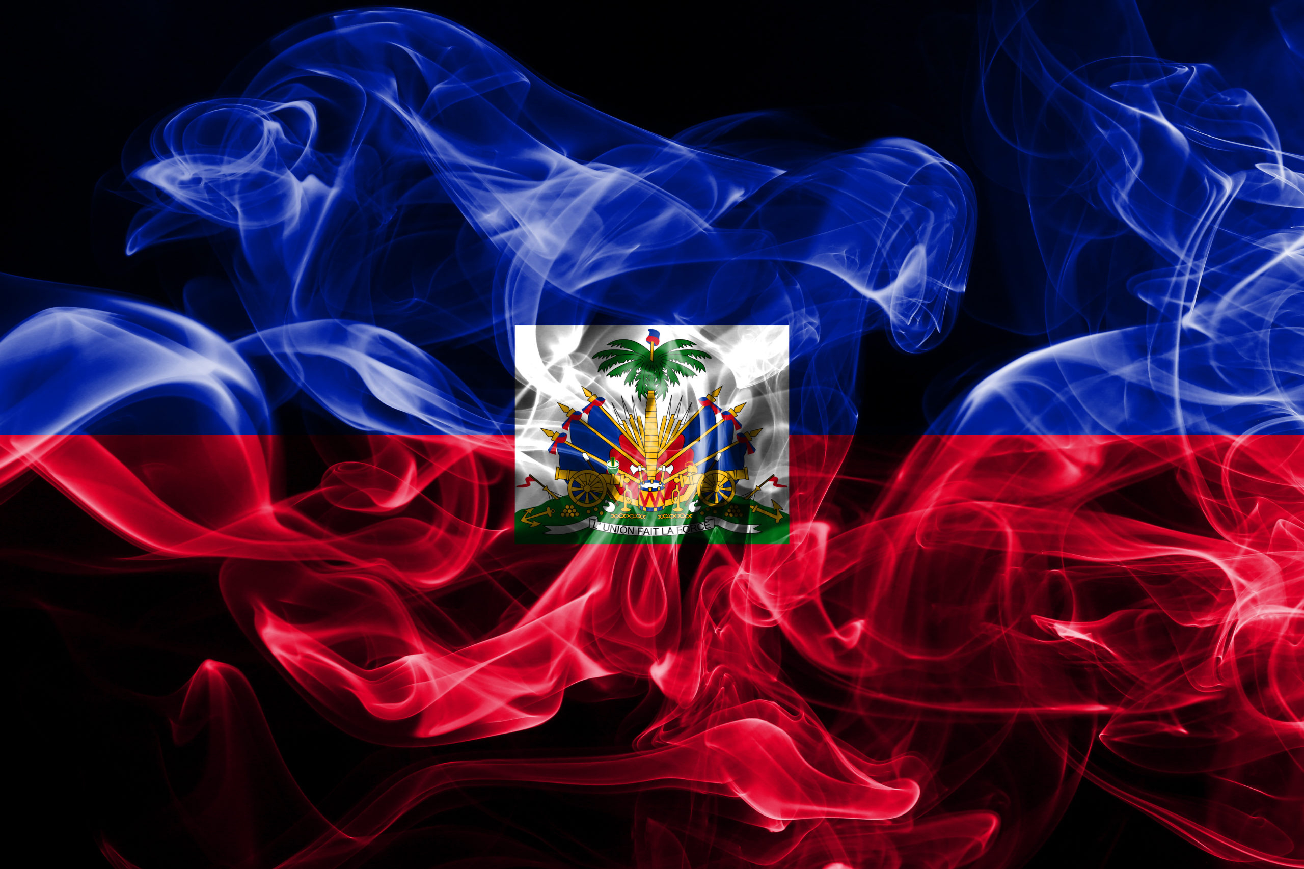 National flag of Haiti made from colored smoke isolated on black background