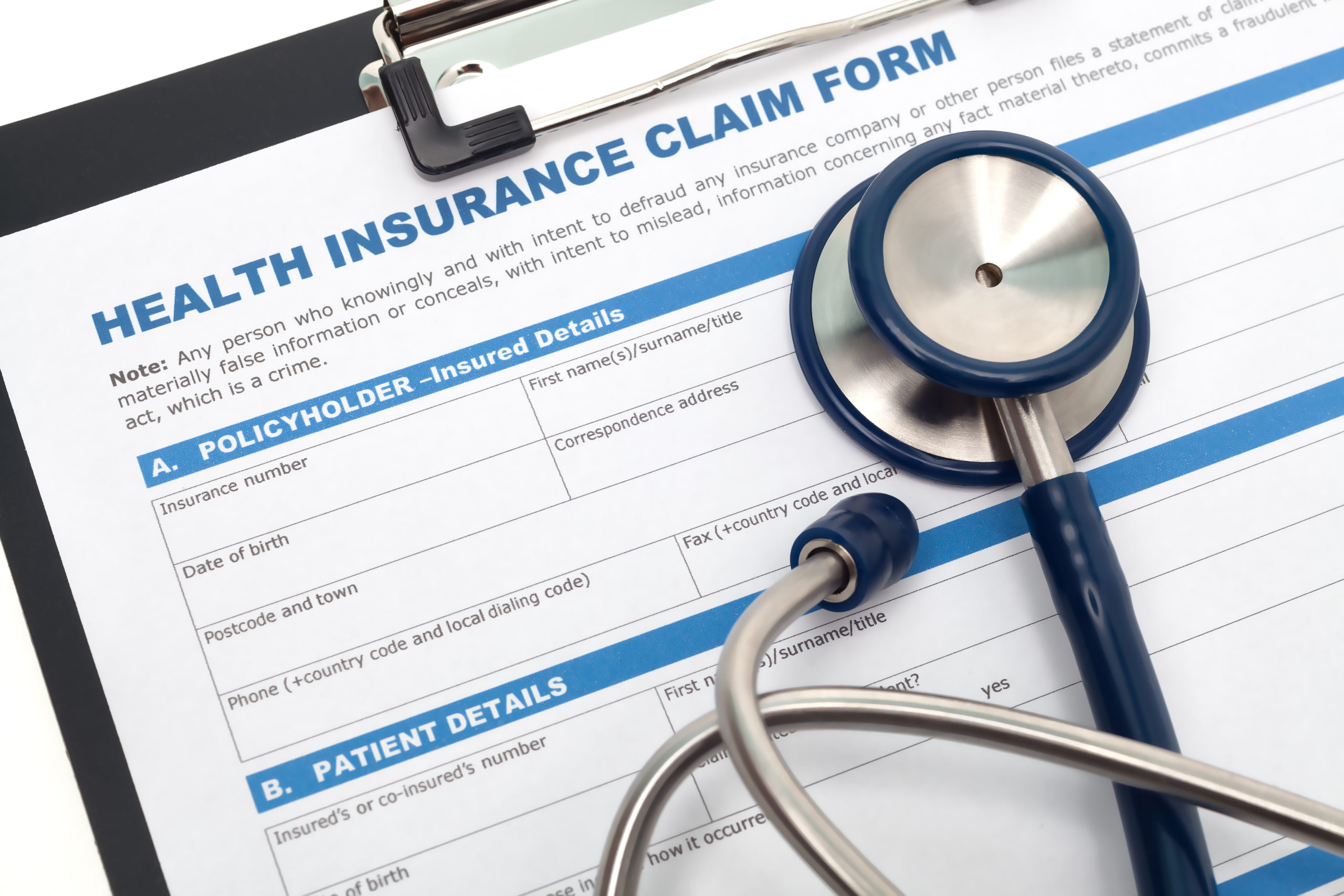 Medical and health insurance claim form with stethoscope on clipboard