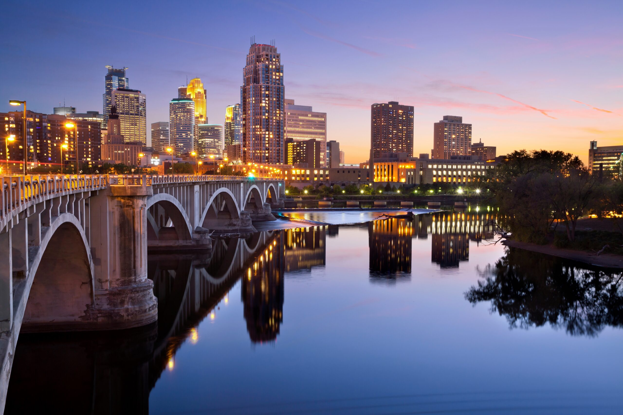 Minneapolis. viewed from across a river with a reflection of a bridge