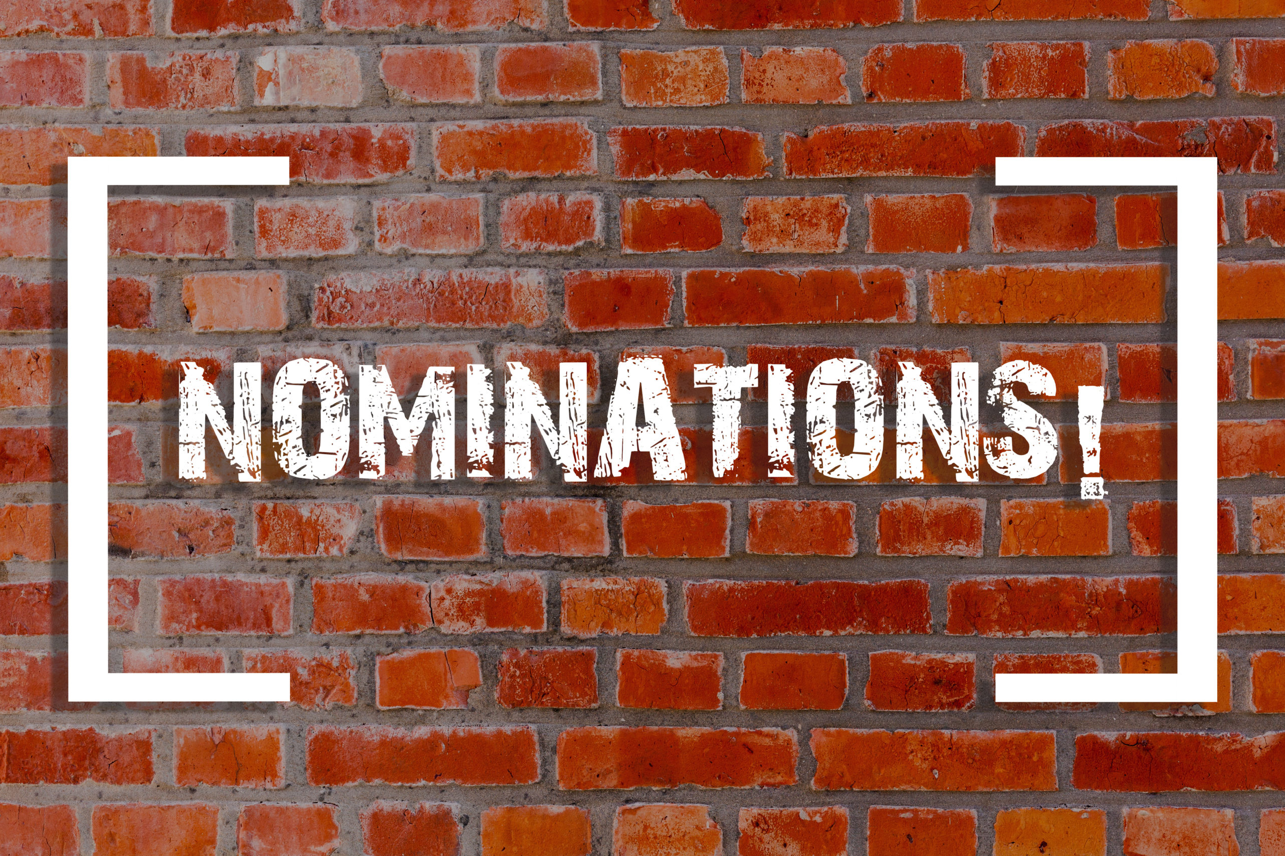 Handwriting text Nominations. Concept meaning action of nominating or state being nominated for prize Brick Wall art like Graffiti motivational call written on the wall.