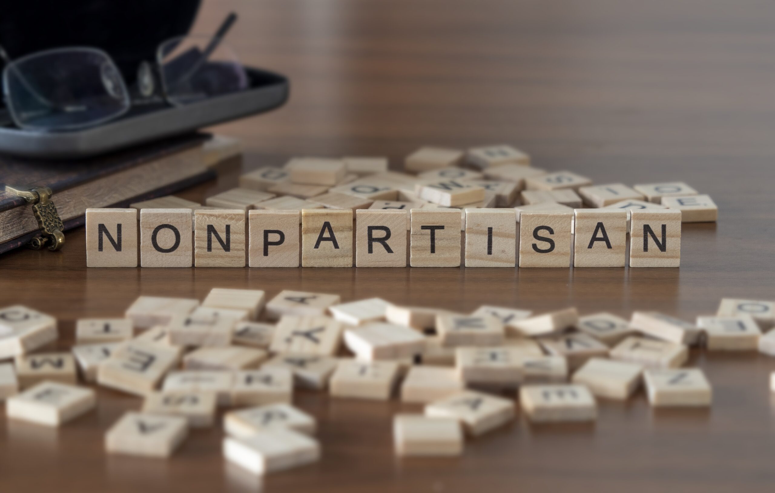 "NONPARTISAN" written out with Scrabble tiles