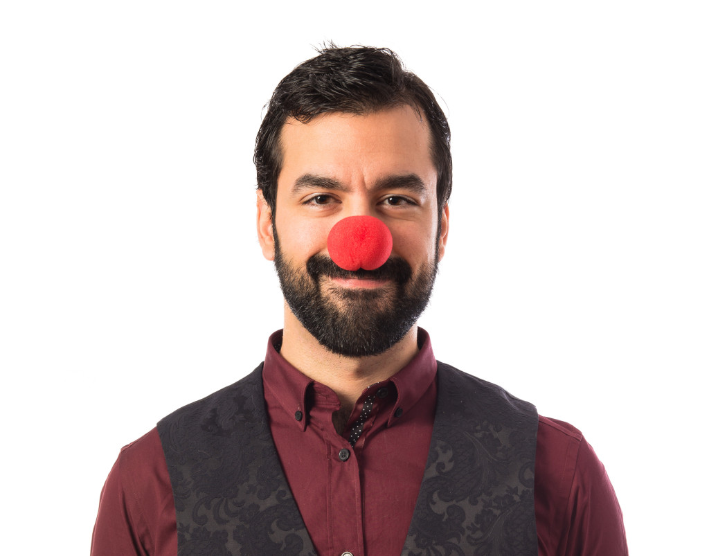 Man wearing waistcoat with clown nose