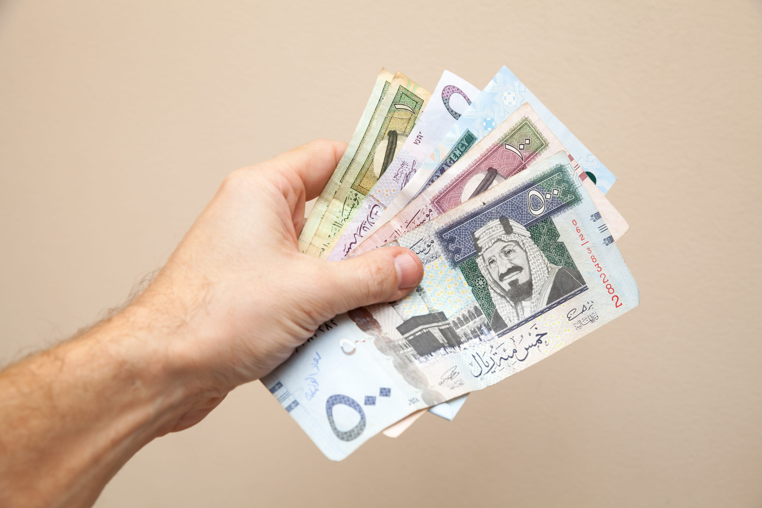 Modern Saudi Arabia money, banknotes in male hand
