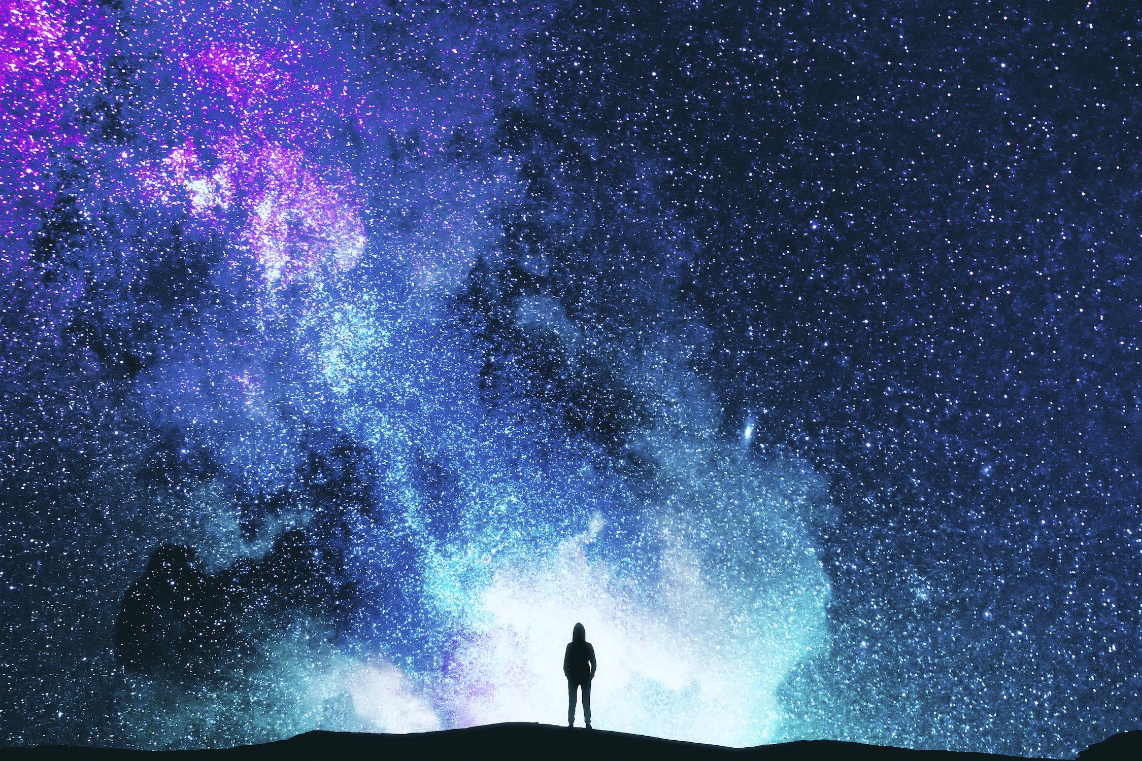 Starry sky background with fmall figure of individual at bottom center