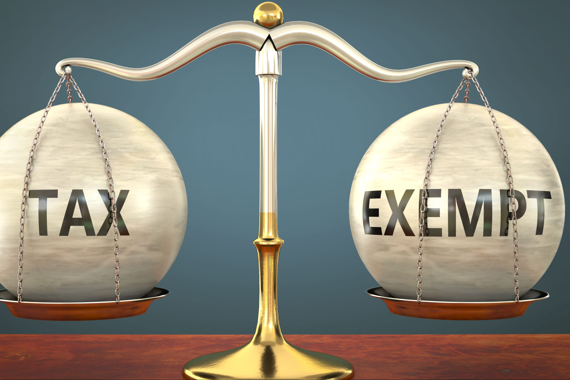 legal scale with the words "tax" and "exempt" on opposite sides