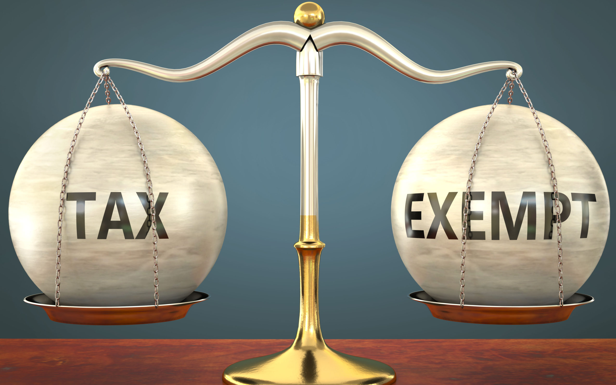 legal scale with the words "tax" and "exempt" on opposite sides