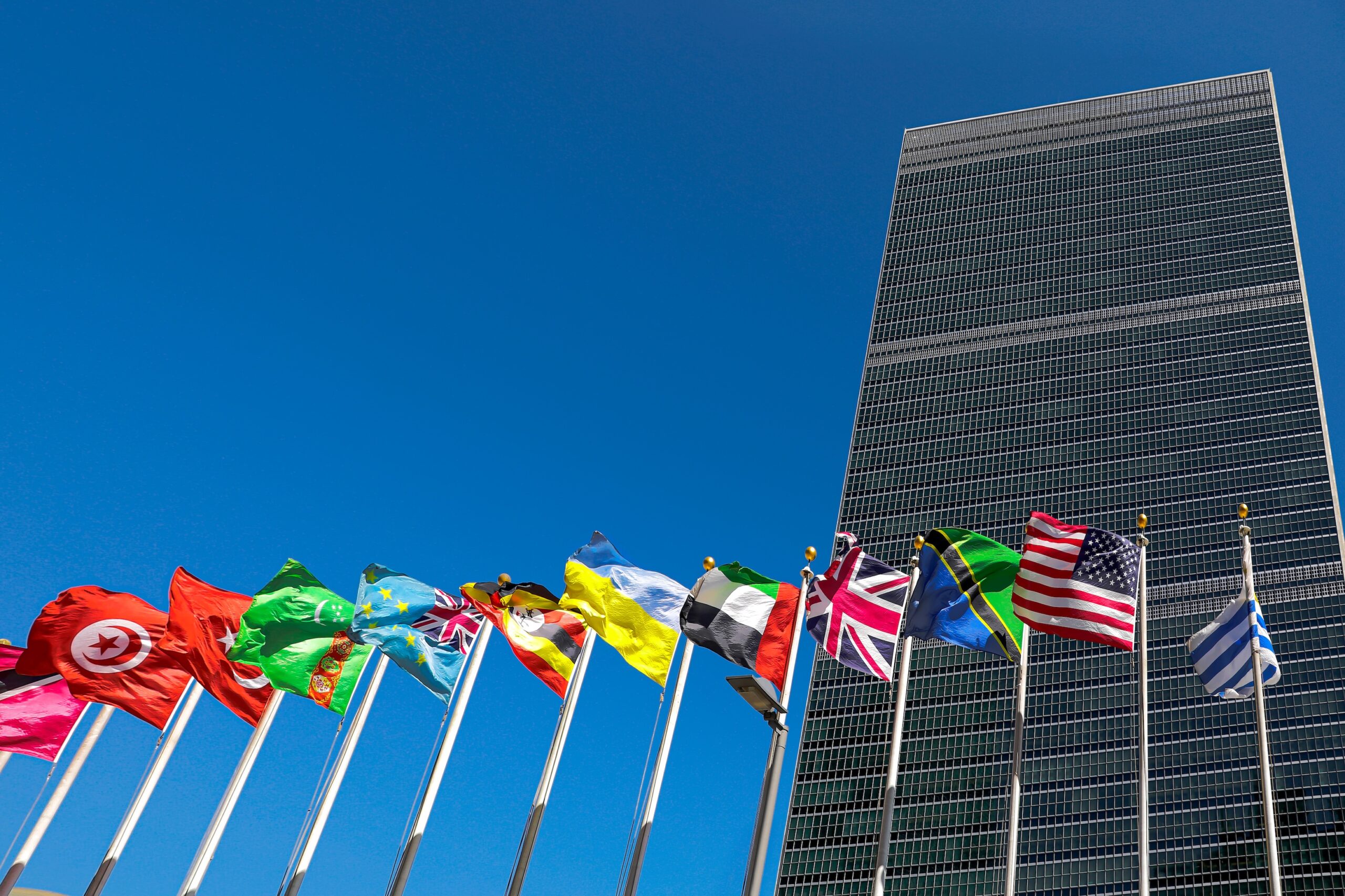United Nations headquarters with several flags in the foreground