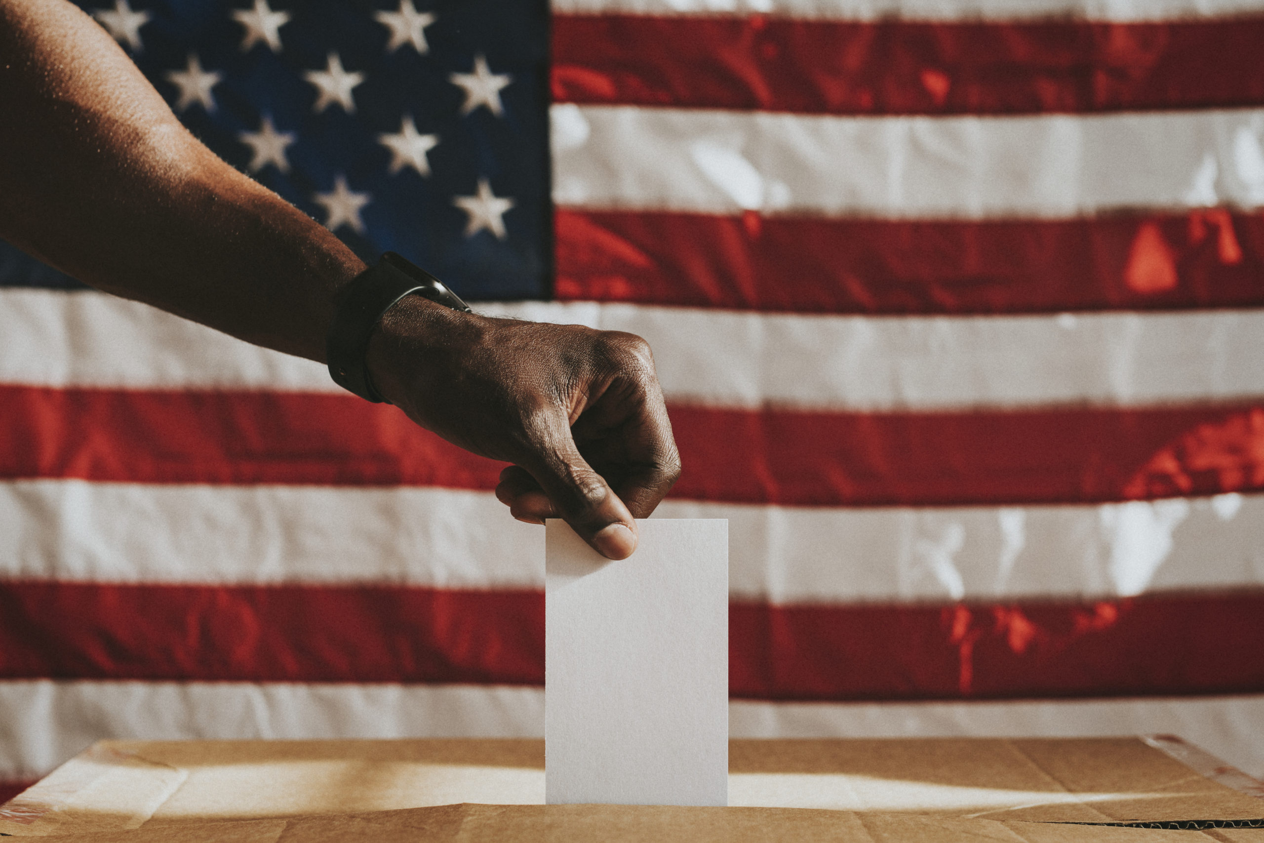 American casting his vote to a ballot box