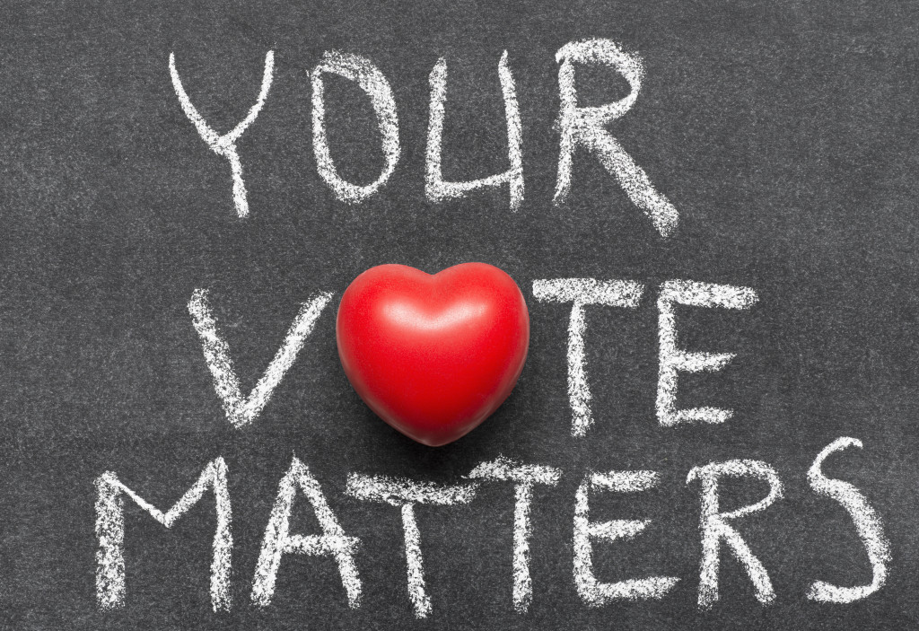 your vote matters phrase handwritten on blackboard with heart symbol instead of O